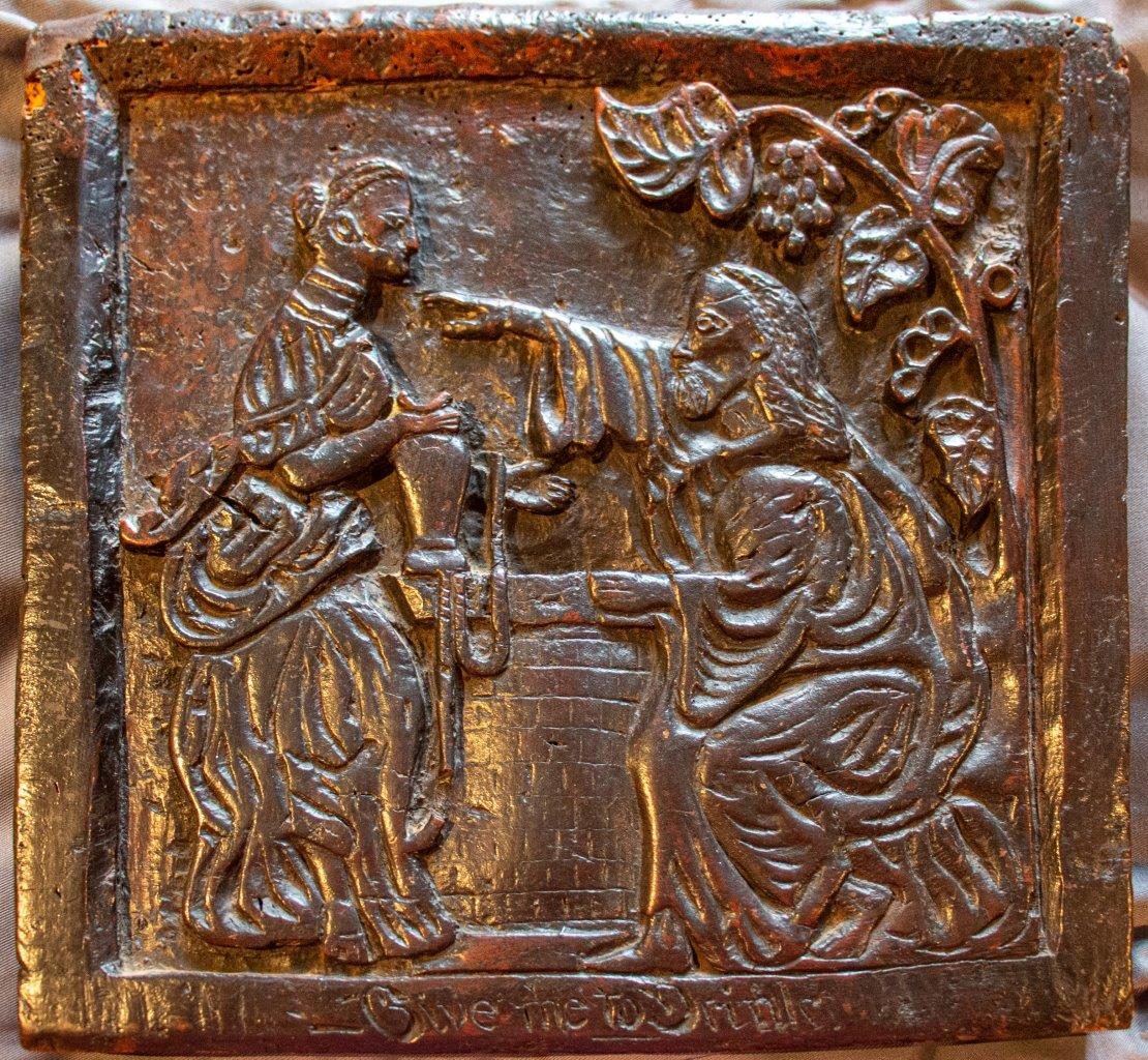 A rare C17th carved burr oak panel, English ‘Rebecca and Eliezer at the Well’